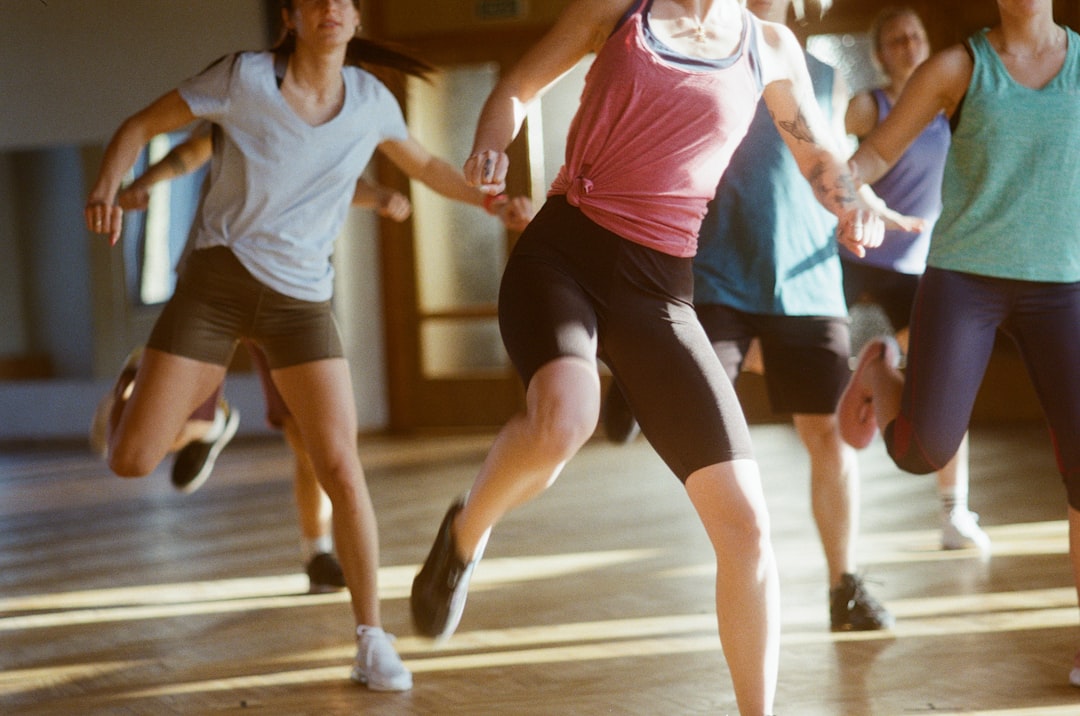 group-of-women-running-on-brown-wooden-floor-vdx-2lsuhm0